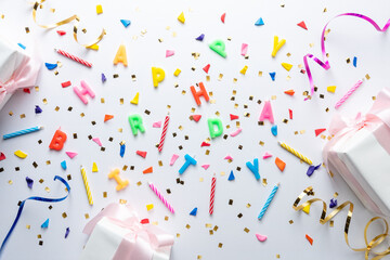 Creative composition made with gift boxes and party streamers on white background. Minimal...