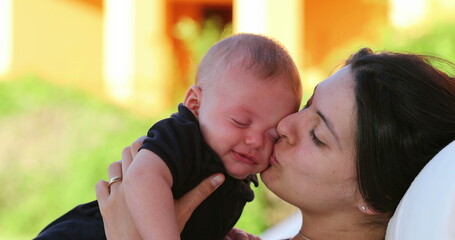 Mom calming crying baby infant outdoors showing love affection and care