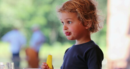 Little boy toddler thinking in contemplation while chewing