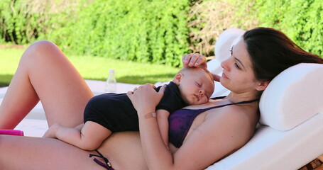 Mother and baby infant together by the swimming pool 4 month old baby taking nap with mom