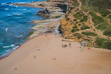Groups of people taking surf lessons on the sand of Ribeira D'Ilhas beach, Ericeira PORTUGAL