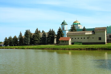 A building with a dome on top by a body of water