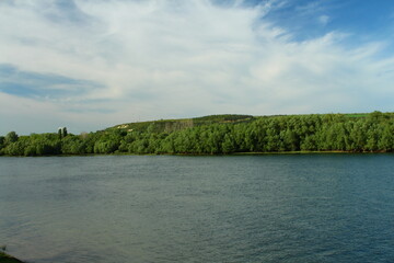 A body of water with trees on the side