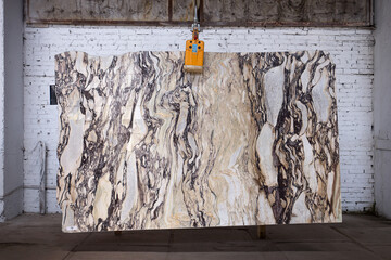 Picture of a marble slab on a hanger, shot in natural light, a cut of decorative marble in a...