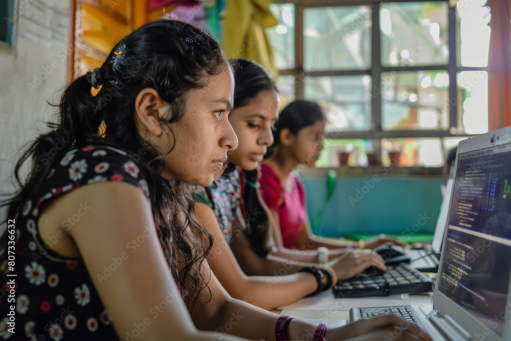 Poster young women engaged in computer programming in a classroom setting