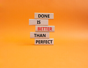 Done is better than Perfect symbol. Wooden blocks with words Done is better than Perfect. Beautiful orange background. Business concept. Copy space.
