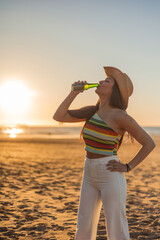 vertical Carefree Beach Evening: Young Latina Enjoying Sunset Beer