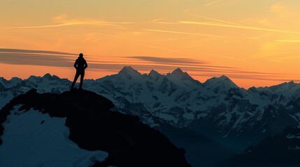 Majestic Silhouette: A Lone Adventurer Amidst Snow-Capped Mountains at Sunset