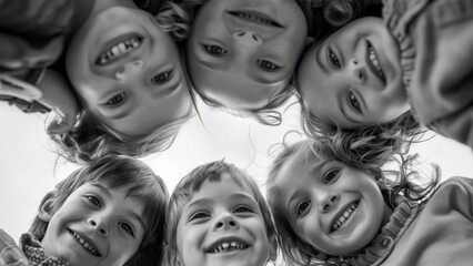 A group of childrne looking down at a camera smiling
