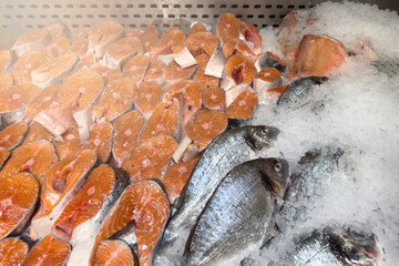 Frozen sea bass in a store close-up. Selection of frozen fish in a supermarket or market.