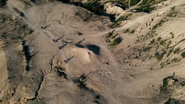 Motorcycle racers on the motocross track, ride off-road and jump over sand hills in Dolomite Quarry, Conisbrough, UK