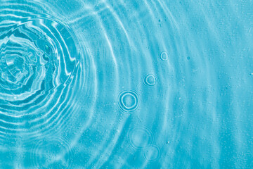 drops on water with circles on a blue background