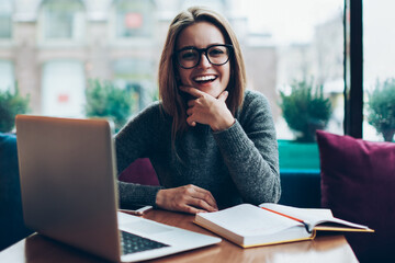 Portrait of successful smiling hipster woman  satisfied with freelnce job modern laptop computer,...