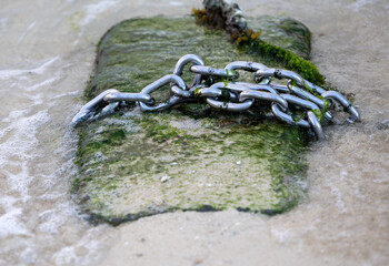 Steel chain on concrete by the sea