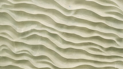 A texture of ripples on sand, with small waves on the surface, light green tint.