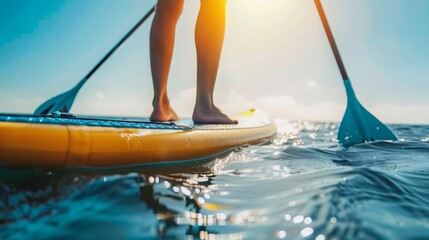 A person is balancing on a paddle board in the water, exhibiting skill and concentration.