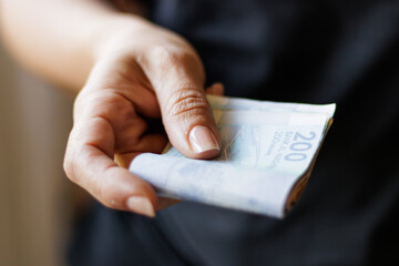 Hand holding Moroccan banknotes, dirham official currency of Morocco.
