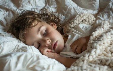 Young child sleeping peacefully in soft white bedding.