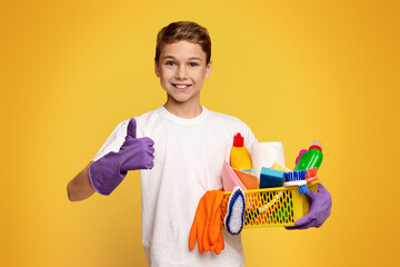 A young boy is shown standing with a basket filled with cleaning supplies.