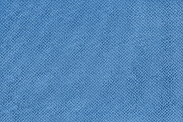 Plain blue velor upholstery fabric, jacquard with fine diamond texture background. Close up, macro cloth textile surface. Wallpaper, backdrop with copy space
