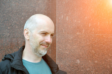 Close-up portrait of a smiling unshaven village guy in dirty clothes.