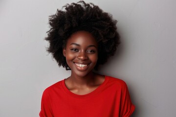 A woman in a red shirt smiling at the camera, suitable for various projects