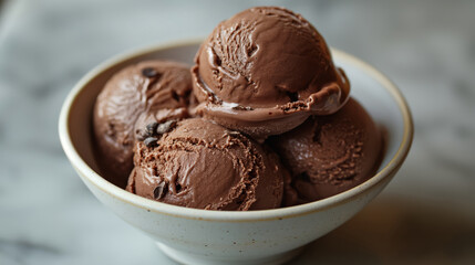 Multiple Scoops of Silky Chocolate Ice Cream, Presented in a Stylish Ceramic Bowl on a Marble Background