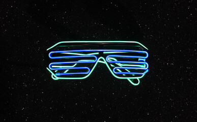 glowing neon glasses isolated on black background