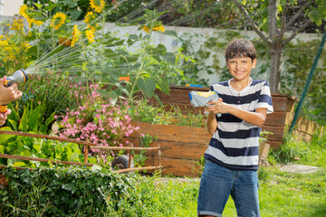 Teenager engages in water play, hold squirt gun ready to attack
