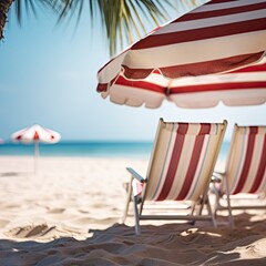 Deckchair under a striped umbrella, blurred background, copy space