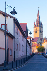 Streets of Sibiu with famous tower of Lutheran Cathedral, Transylvania, Romania
