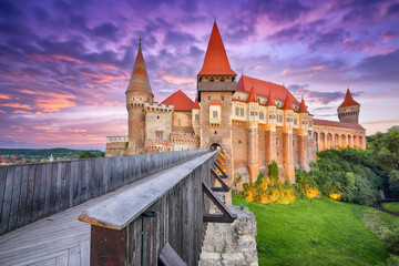 Fabulous evening view of Hunyad Castle / Corvin's Castle with wooden bridge at sunset