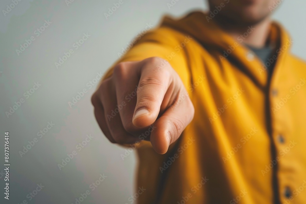Poster A man in a yellow jacket pointing at the camera. Suitable for business and communication concepts