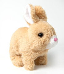 Soft fluffy rabbit toy with long ears, isolated on a white background