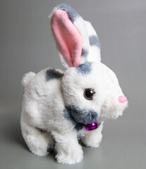 Soft fluffy rabbit toy with long ears, isolated on a white background