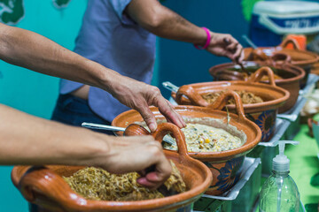 Latina women serving taco stews from their working women's venture