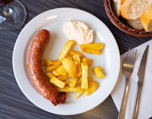 Traditional Spanish dish with sausages served with potatoes and spicy aioli