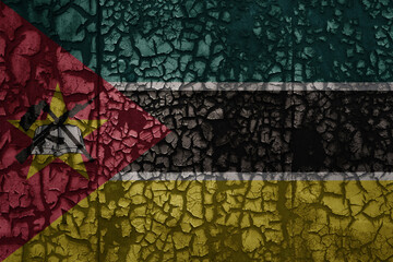 flag of mozambique on a old grunge metal rusty cracked wall background