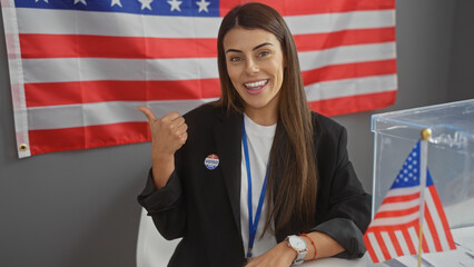 A young hispanic woman with an 'i voted' sticker, pointing to the american flag at an electoral college.