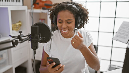 African american woman singing in a music studio