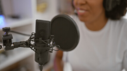 African american woman singing in a music studio