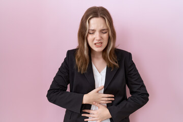 Young caucasian business woman wearing black jacket with hand on stomach because indigestion, painful illness feeling unwell. ache concept.