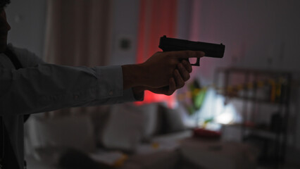 Hispanic man holding pistol in dimly lit indoor crime scene