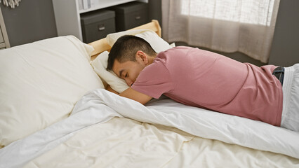 A young hispanic man sleeps peacefully in a cozy bedroom setting, evoking a sense of relaxation and domestic comfort.