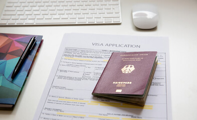 Top view of a visa application document with a German passport
