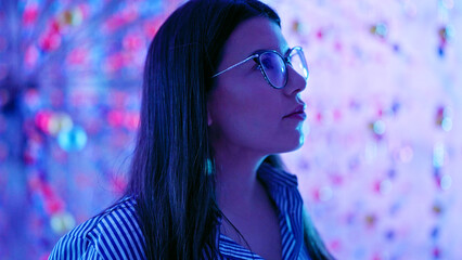 Young beautiful hispanic woman visiting futuristic exhibition space