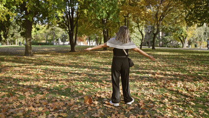 A tranquil woman enjoys autumn tranquility in a park, surrounded by fallen leaves and nature's serenity.