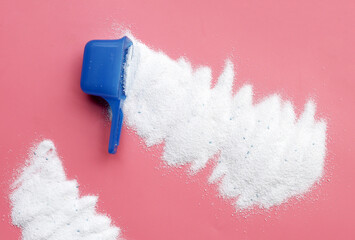 Detergent powder with measuring spoon. Laundry concept.