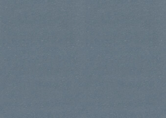 Seamless dark blue grey paper texture with little small pieces of straws and fibers. Smooth cardboard surface.
