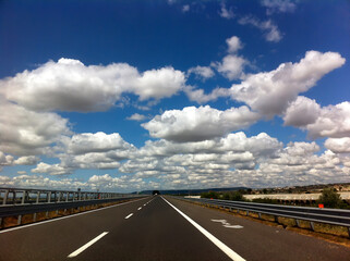 Italian highway without cars with white clouds in the sky